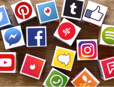 social media marketing icons showing social media marketing strategy in action on a wooden background.